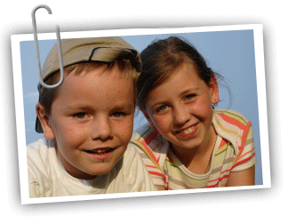 Boy/girl adolescent twin pair both looking at the camera and smiling