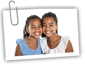 Twin African American teenage girls smiling